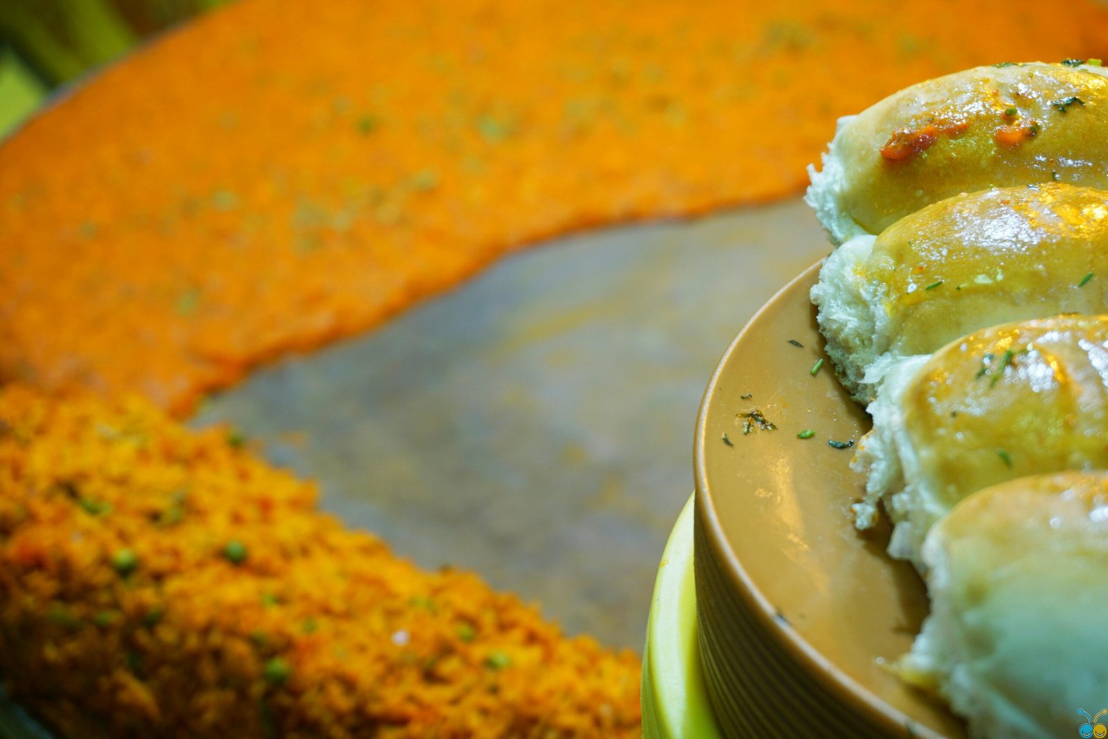 Fresh bread rolls with Indian pav bhaji curry, perfect for a flavorful meal.